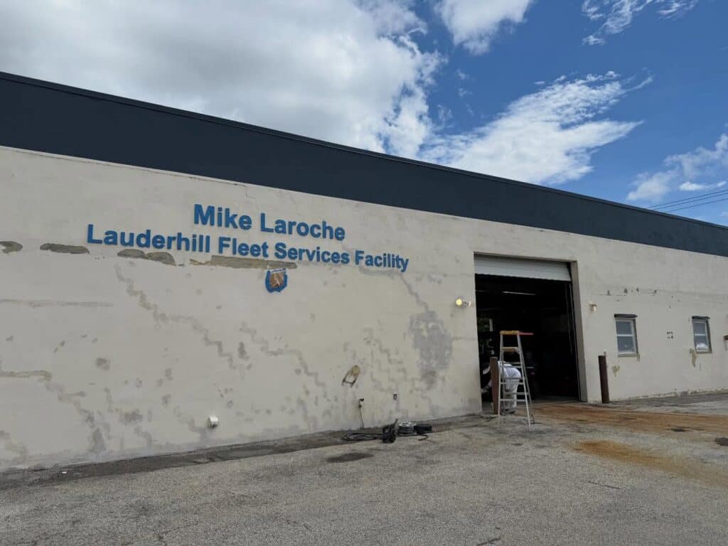 Exterior facility walls exhibiting severe structural cracking, heavy mold colonization, and moisture intrusion before project start.